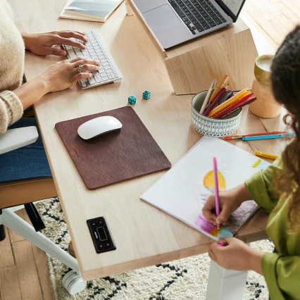 People working at a shared desk