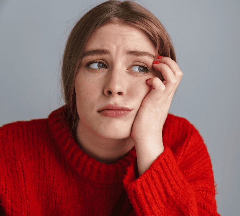 person in red sweater looking puzzled